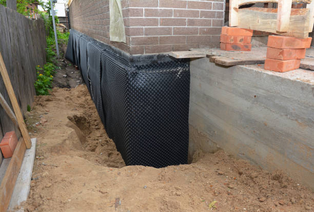 Happy homeowners after waterproofing job in Lapel